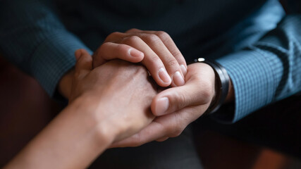 Close up African American man comforting woman, holding hands, expressing love and support,...