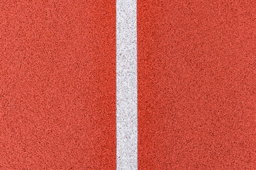 Close up on a white line in artificial red turf, on a street basketball, handball, volleyball,...