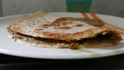piece of Indian egg dosa on a plate
