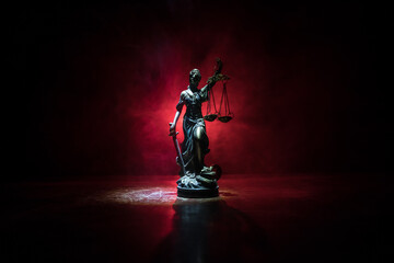 Obraz na płótnie Canvas The Statue of Justice - lady justice or Iustitia / Justitia the Roman goddess of Justice on a dark fire background