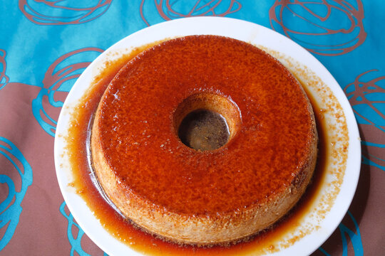 sweet homemade round flan cake closeup detail dessert with tasty caramel syrup traditional dish of Spain 
