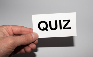 Message on the card QUIZ, in hands of businessman.