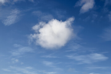 Naklejka na ściany i meble flying Cumulus clouds against a blue sky