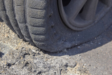 wheels and wheels of a burned-out car in one of the city's districts