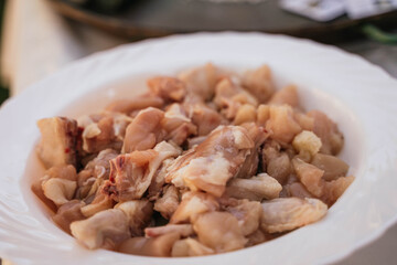 chicken on a white plate to prepare a typical Spanish paella with paella pan