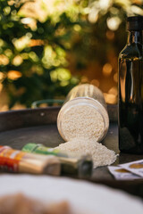 Rice, olive oil and seasonings to prepare typical Spanish paella on black paella pan