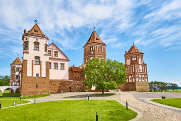 Fototapeta premium Mir castle complex in summer day with blue cloudy sky. Tourism landmark in Belarus, cultural monument