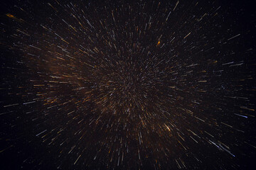 Meteor shower against the background of the black night sky and stars.