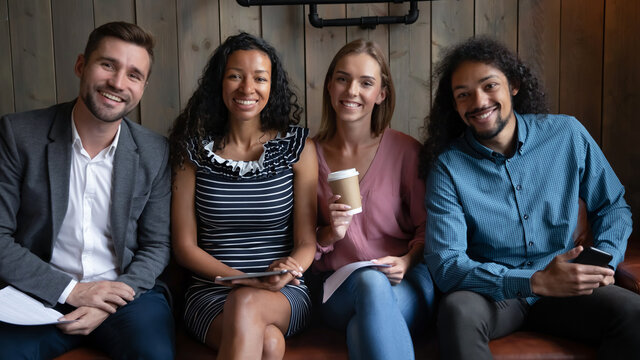 Group Portrait Smiling Happy Young Diverse Candidates Seekers Unemployed People Sitting In Row, Waiting For Job Interview In Queue, Looking At Camera, Employments And Recruitment Concept