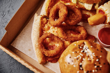 Unhealthy and junk food. Different types of fast food on the table, closeup
