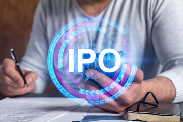 Double exposure of man signing contract with phone and ipo hologram. Concept of initial primary...