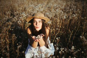 Leisure activities, sunscreen, summer, freedom. Young cute freckled woman on summer meadow. Seasonal outdoor walk