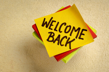 welcome back - handwriting on a sticky note, greetings and business reopening concept