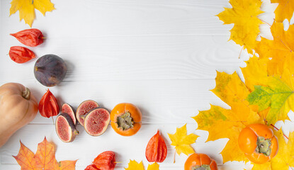 Autumn concept with seasonal fruits and vegetables. Pumpkin, figs, autumn leaves. Autumn background. Copy of the space.