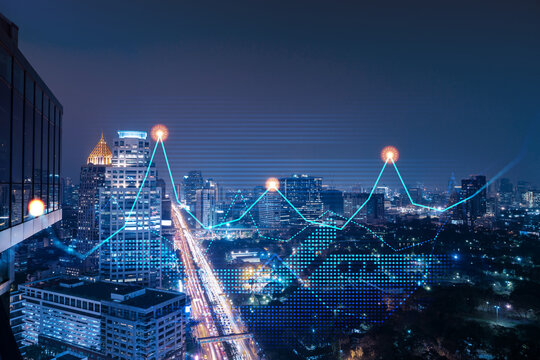 Stock market graph hologram, night panorama city view of Bangkok, popular location to gain financial education in Asia. The concept of international research. Double exposure.