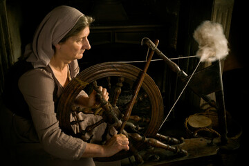 Medieval woman with spinning wheel
