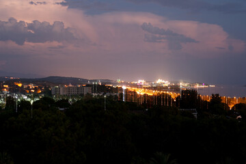 Lightning flashes in the night sky before the start of a thunderstorm, city, Turkey