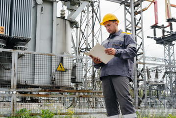 The energy engineer inspects the equipment of the substation. Power engineering. Industry