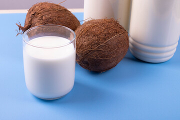 coconut lactose free milk in plastic bottles on blue surface