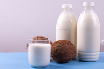 coconut lactose free milk in plastic bottles on blue surface