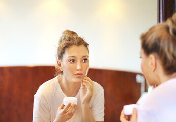 Magic anti-aging cream.Applying the cream. woman moisturizing face mask. Cosmetology and skin care concept.