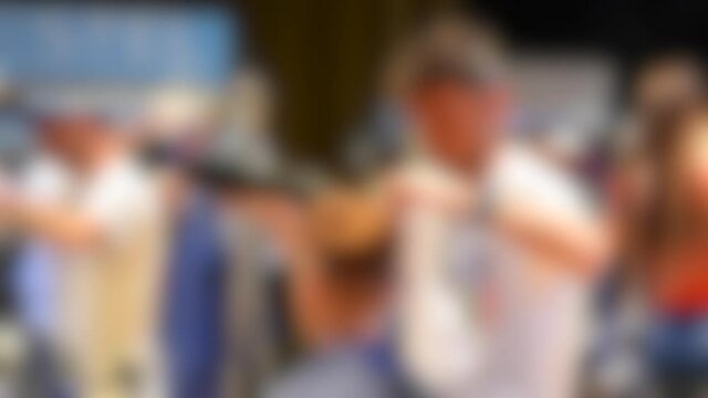 Blurred background. Male hairdressers making hair girl model close-up