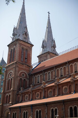 Fototapeta na wymiar Ho Chi Minh City, Vietnam - March 2nd, 2020: Facade of the Notre-Dame Cathedral Basilica of Saigon officially Cathedral Basilica of Our Lady of The Immaculate Conception