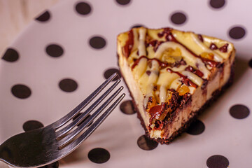 Slice of gourmet cheese cake on a plate.