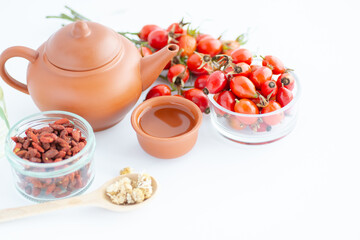 Dog rose, bunch branch Rosehips, types Rosa canina hips and herbal tea - Medicinal plants herbs composition