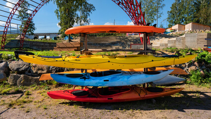 multicolored kayaks stacked on a rack