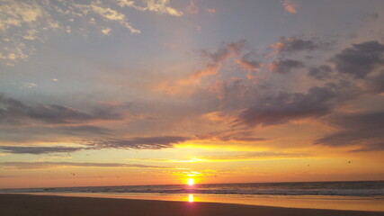 Fototapeta na wymiar Sunrise over the Beach