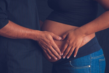 Pregnant woman on a black background 