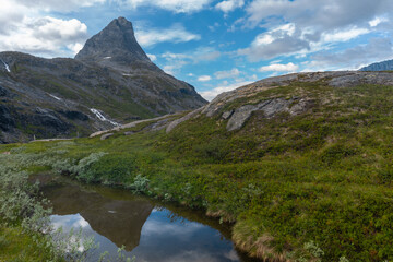 Fototapeta na wymiar Beautiful mountain landscapes on the road approaching Trollveggen (Troll Wall) part of the mountain massif Trolltindene (Troll Peaks) in the Romsdalen valley, Norway.