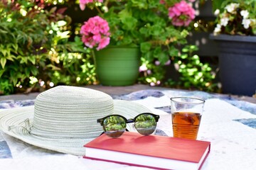 Relaxing outdoor afternoon with book and tea for enjoying a warm summer day during staycation vacation
