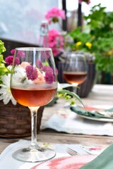 Outdoor cafe restaurant setting for warm summer evening romantic dinner dates in sheltered patio with beautiful table decor and wine