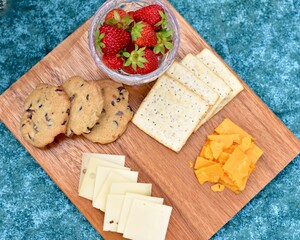 Outdoor summer gourmet picnic basket foods in beautiful romantic garden setting for special staycation relaxing meal on warm evening to share with someone special