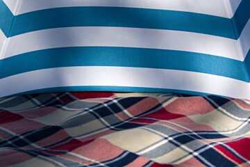 striped awning in soft shadow on plaid  blurred background