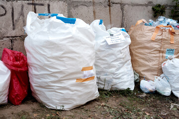 Volunteer ecological action for separate waste collection. Huge bags full of plastic bottles collected for further recycling