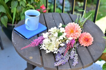 Relaxing outdoor balcony space for working from home or reading on warm seasonal days in summer with beautiful landscaped gardens in background for mindfulness space