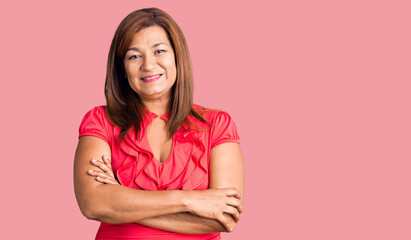 Obraz premium Middle age latin woman wearing casual clothes happy face smiling with crossed arms looking at the camera. positive person.