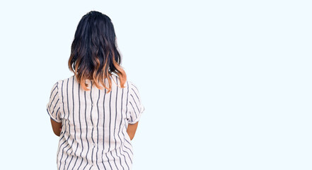 Young woman wearing casual clothes standing backwards looking away with crossed arms