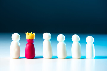 The concept of a working team. Employees and their leader. Figures of people symbolize workers. Labor subordination. The team is managed by a boss in the crown.
