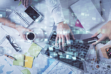 Double exposure of man's hands typing over computer keyboard and data theme hologram drawing. Top view. Technology concept.