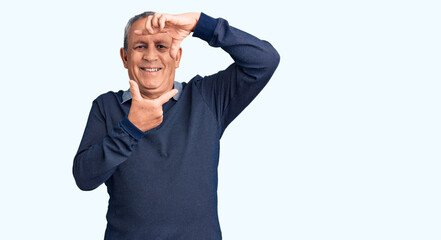 Senior handsome man wearing casual polo smiling making frame with hands and fingers with happy face. creativity and photography concept.