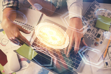 Double exposure of man and woman working together and crypto theme hologram drawing. Computer background. Blockchain concept. Top View.