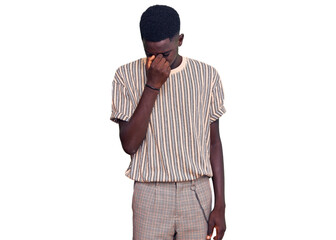 Young african american man wearing casual clothes tired rubbing nose and eyes feeling fatigue and headache. stress and frustration concept.