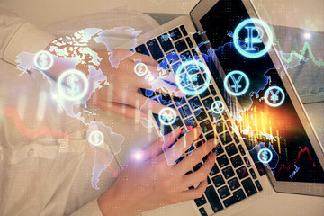 Double exposure of woman hands working on computer and forex graph hologram drawing. Top View. Financial analysis concept.
