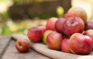 apples on the wood box in the nature blurred background with bokeh lights

