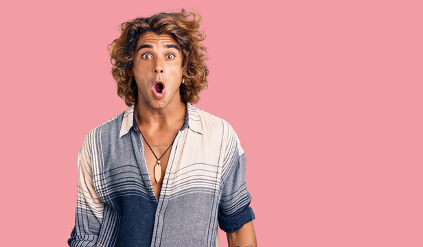 Young hispanic man wearing summer style afraid and shocked with surprise expression, fear and excited face.