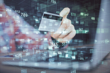 Double exposure of man hands holding a credit card and data theme drawing. E-commerce and technology concept.